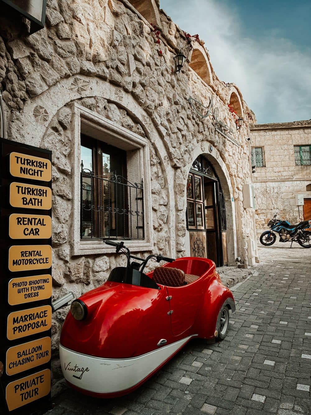 Vintage sidecar outside a stone building